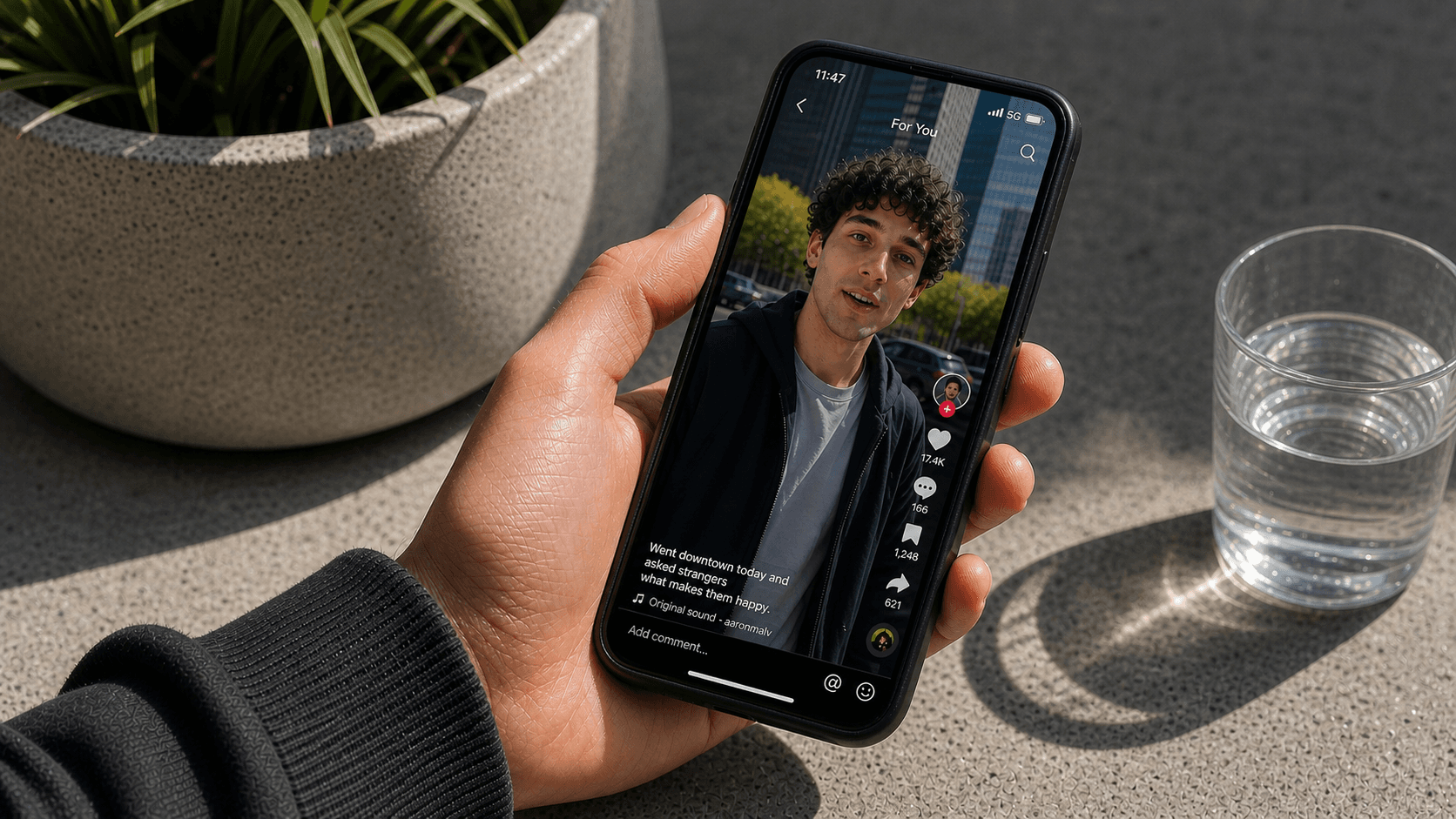 A smartphone screen displaying a social media video with bold caption overlays visible on the screen, the phone held in a hand in a quiet environment, soft modern lighting, clean and minimal aesthetic, no sound waves or audio indicators visible, captions clearly displayed on the video frame